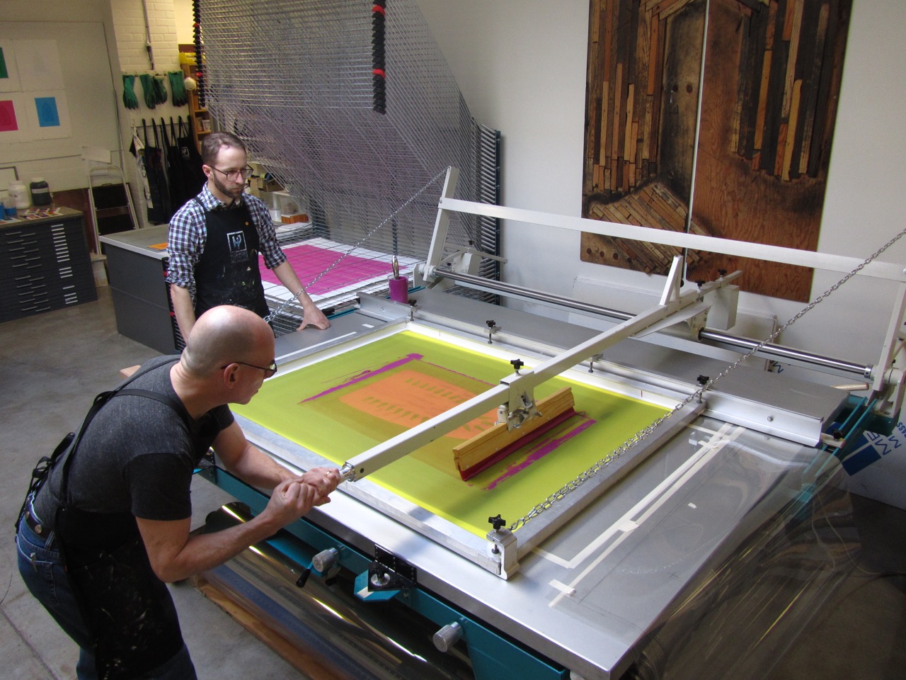 HP_Cole_Zac_screenprinting_2012 ‘Master Printer Cole Rogers and Senior Printer Zac Adams-Bliss editioning Willie Cole’s large-scale screenprints, 2012. Image Courtesy of Highpoint Editions”